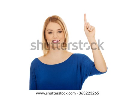 Young woman pointing up.