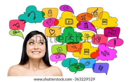 Young smiling woman looking upwards, coloured icons depicting functions of social networks above her head and around. White background. Concept of social networks.
