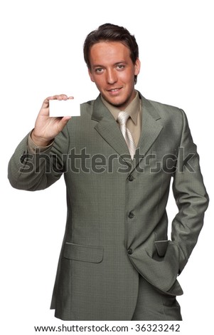 Successful young businessman in suit showing blank business card over white background