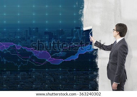 Young businessman painting a picture of New York city centre on a concrete wall with a roller as if it were a background for financial graphs. Concrete wall. Conceft of finance centre.