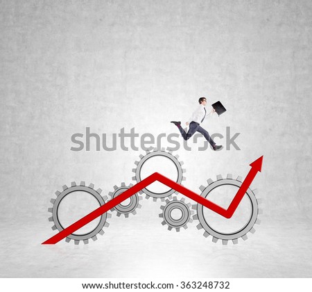 Young businessman with a folder in hand running up a red drawn graph on a concrete wall with pictures of gears. Concept of career growth.