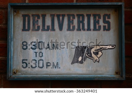 Sign of a guide of business hours.Street Sign for Opening Small Business.featuring a sign advertising delivery available during the pandemic.