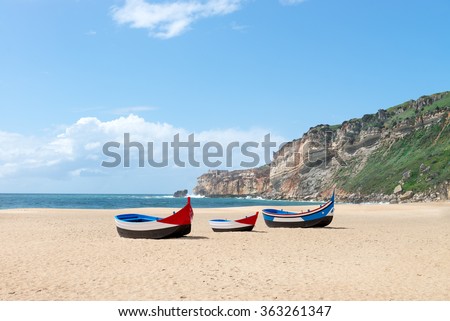 Main beach in Nazare with Traditional colorful boat on the sand - Nazare, Portugal Royalty-Free Stock Photo #363261347