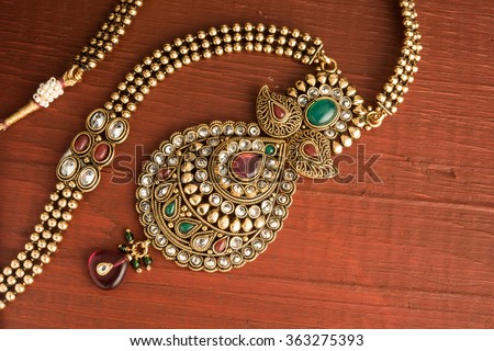 Indian traditional jewellery over wooden background, Selective focus Royalty-Free Stock Photo #363275393