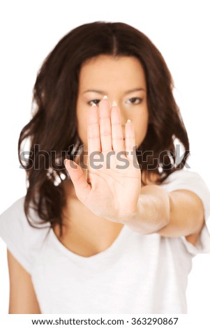Young woman making stop gesture.