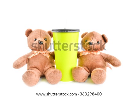 green paper cup and Teddy Bear isolated on white background