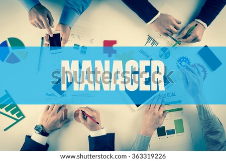 Business team working on desk with MANAGER word