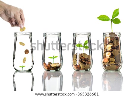 Hand putting gold coins into clear bottle on white background,Business investment growth concept
