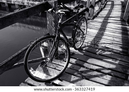 Black and white a bicycle on the wooden bridge