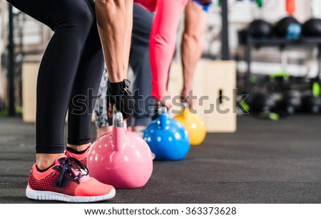 Group having functional fitness training with kettlebell in sport gym Royalty-Free Stock Photo #363373628