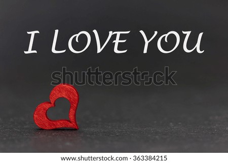 a red heart and text against a dark background