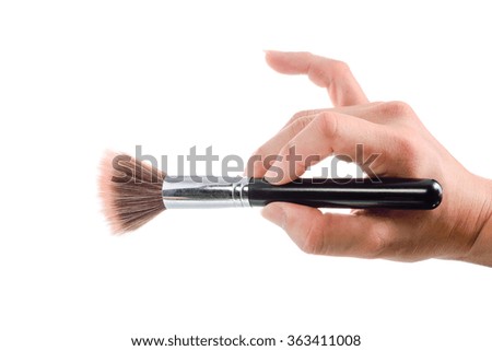 Make up paintbrush in hand on white background