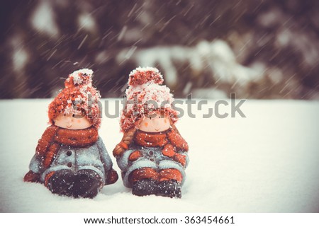 Two dolls at snow, toned