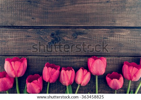 Row of tulips on wooden background with space for message.  Mother's Day background. Top view Royalty-Free Stock Photo #363458825