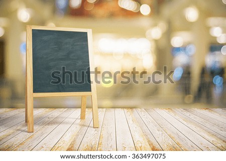 Blank restaurant blackboard on wooden floor, mock up