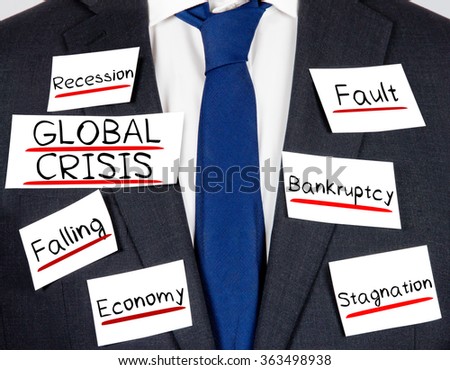 Photo of business suit and tie with GLOBAL CRISIS conceptual words written on paper cards
