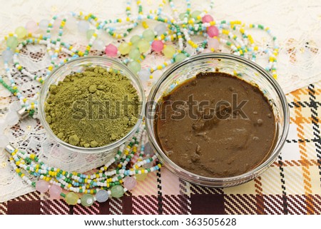 Henna powder. Henna paste. Henna prepared for cosmetic procedures. Still life with henna and beads.
