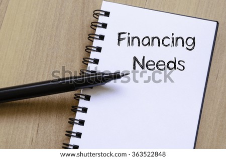 Financing needs text concept write on notebook with pen