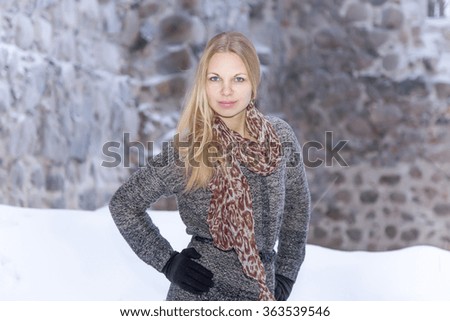 Young woman at old castle in winter