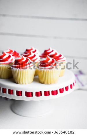 Strawberry and vanilla cupcakes on white background