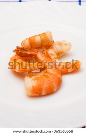 shrimp fried in oil laid out on a white plate