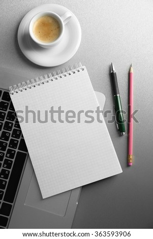 Empty  notebook on laptop keyboard, on light background