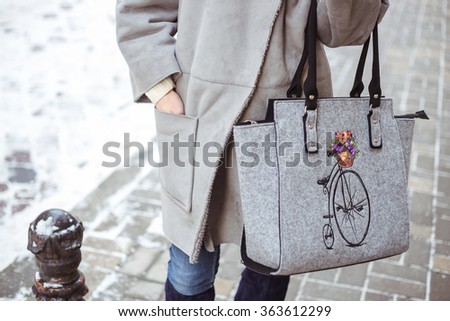 Stylish young fashionable woman with big gray felt bag and deep blue winter boots. Winter street fashion look Royalty-Free Stock Photo #363612299