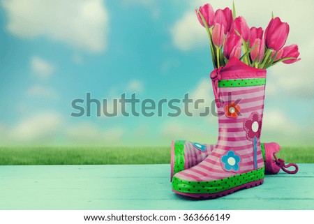 colorful rubber boots on nature background.