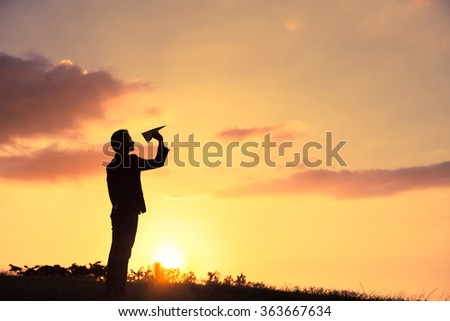 Man in suit throwing a paper plane.  Royalty-Free Stock Photo #363667634