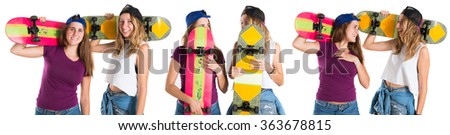 Girls hiding behind their skateboards
