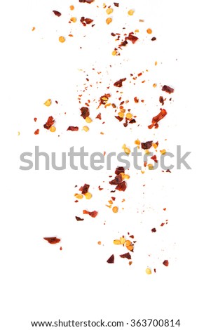Sifting red hot chili pepper's flakes over white background. Royalty-Free Stock Photo #363700814