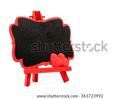 Red frame wooden easel mini blackboard with chalkboard surface, empty space for text and two red heart shape symbols, isolated on white with clipping path, copy space available, Valentines day concept