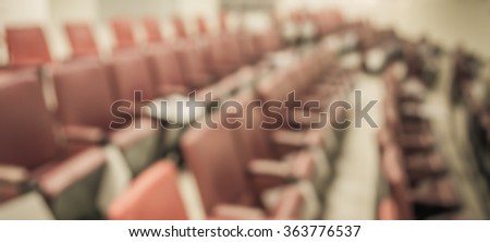 vintage tone blurred image of empty auditorium room , Abstract blur for background usage.