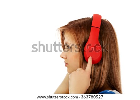 Teenage woman with red headphones