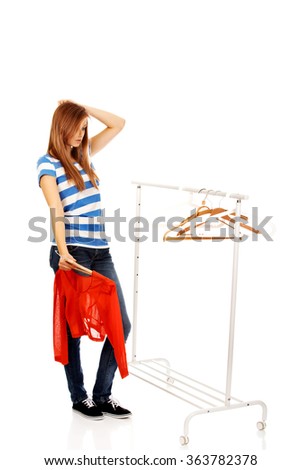 Confused teenage woman with nothing to dress