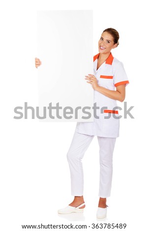 Happy female doctor holding empty banner