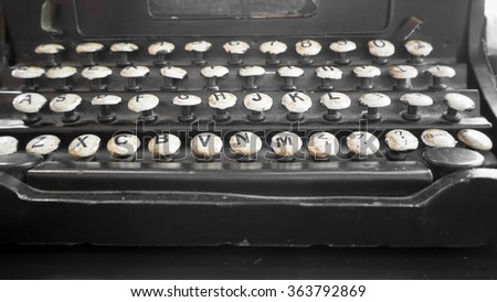 Vintage typewriter on black wood table.