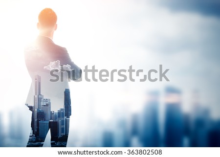 Stylish gentleman in trendy suit. Double exposure skyscraper on the background. Blurred effects.