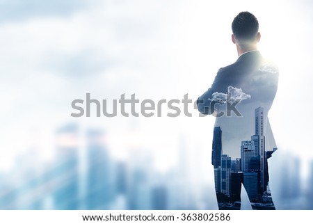 Gentleman in moder suit looking on the city. Double exposure skyscraper background. Blurred effects.