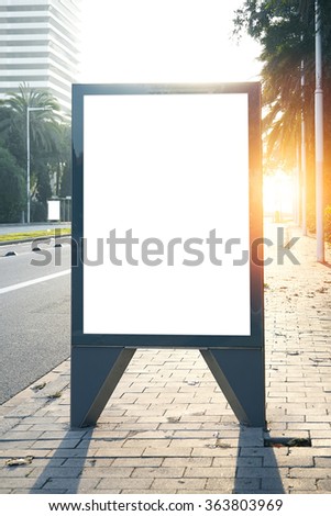 Blank lightbox on the city streets. Vertical. Sunlights effects