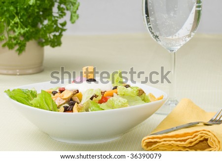 Gourmet chicken taco salad, with sparkling water