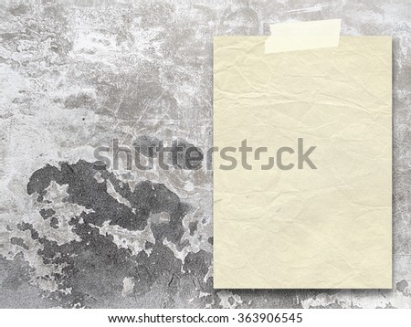 Close-up of one old paper sheet with tape on grey scratched concrete wall background