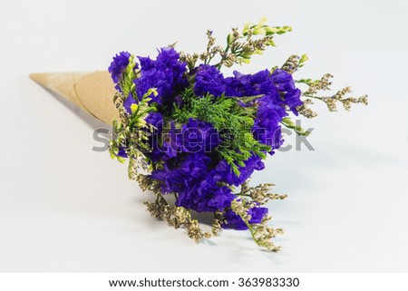 Purple statice flower bouquet on white background.