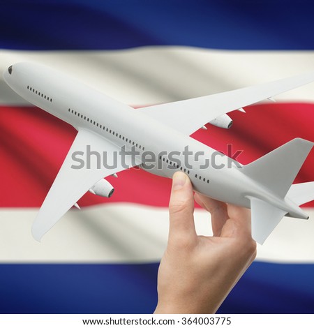 Airplane in hand with national flag on background series - Costa Rica