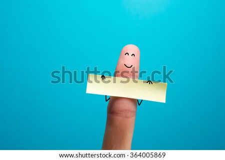 Funny finger holding blank bunner showing on it and smiling