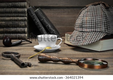 Sherlock Concept. Private Detective Tools On The Wood Table Background. Deerstalker Cap,  Magnifier, Key, Cup, Notebook, Smoking Pipe. Front View Royalty-Free Stock Photo #364021394