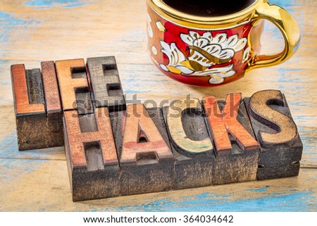 life hacks  - word abstract in vintage letterpress printing blocks stained by color inks with a cup of coffee