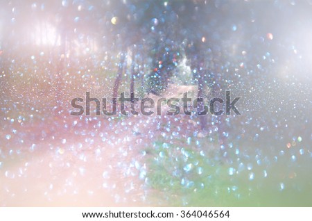 abstract blurred dreamy mystery fairy woods and glitter bokeh lights. filtered image and textured.
