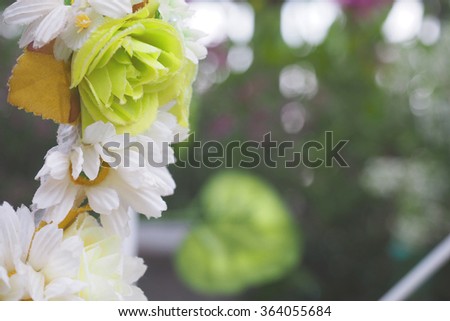 Artificial flowers crown and bokeh background 