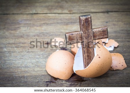 wooden cross in egg shell  on wooden background, Easter  background, with copy space, concept